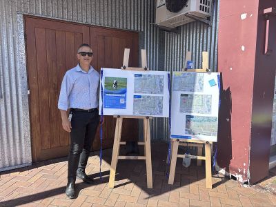 Person with display boards outside IGA in Jamberoo